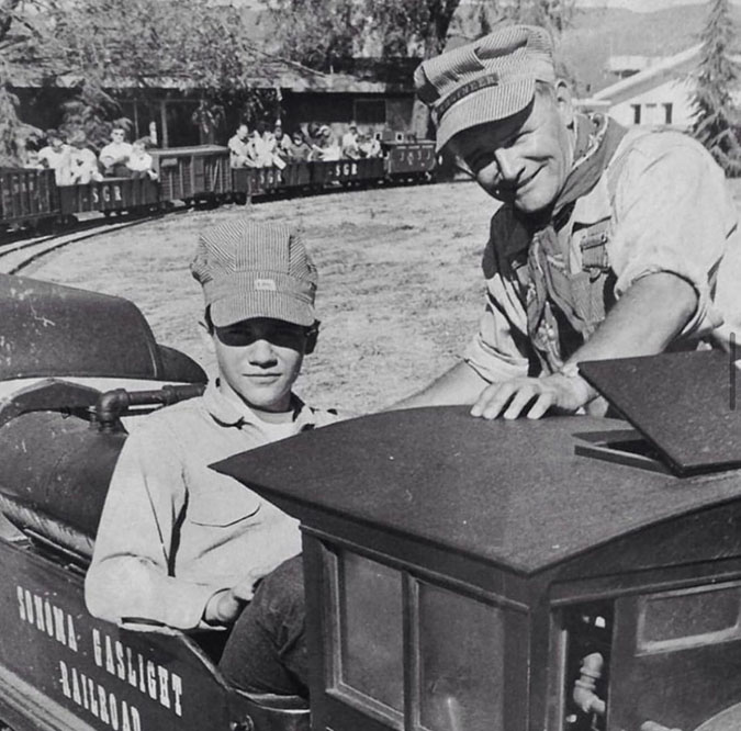 From left: R.B. Frank sits inside a live steam locomotive next to his father, Stanley Frank, at Train Town, 1968.